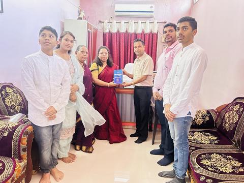 Group photo during a book donation in an office