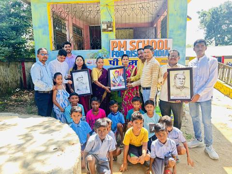 Framed portraits presented to a school, with students and staff"