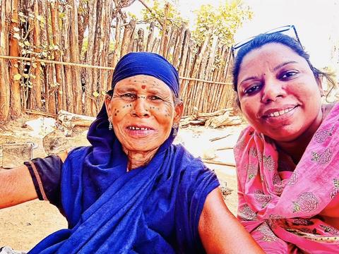 Selfie with an elderly tribal woman with traditional facial tattoos
