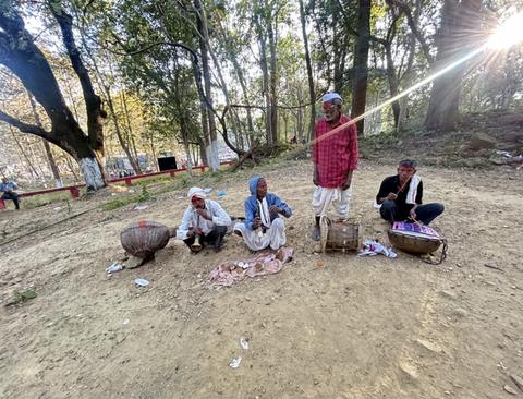 Village drummers with traditional drums in a forest clearing