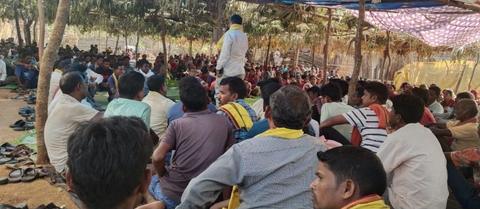 Crowd seated listening to a speaker at a community meeting