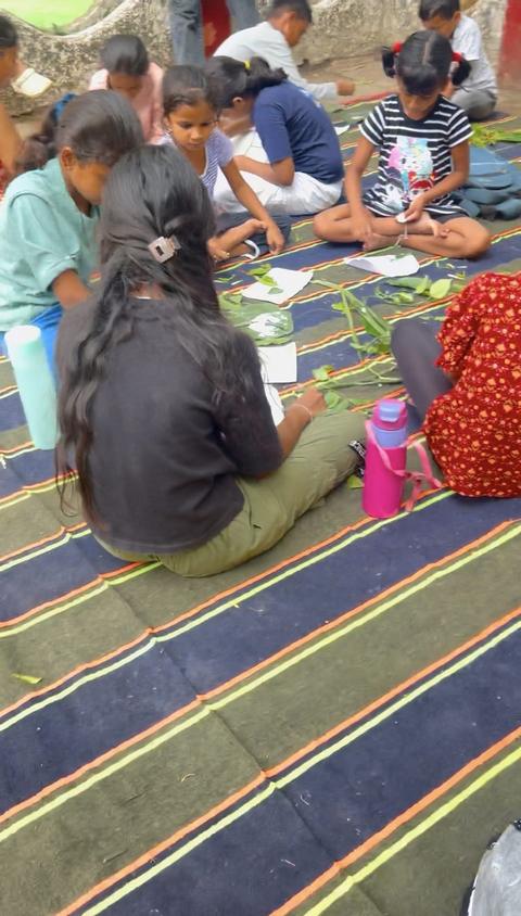 Children doing a leaf craft activity on striped mats