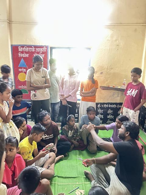Group activity with children seated in a circle at summer camp